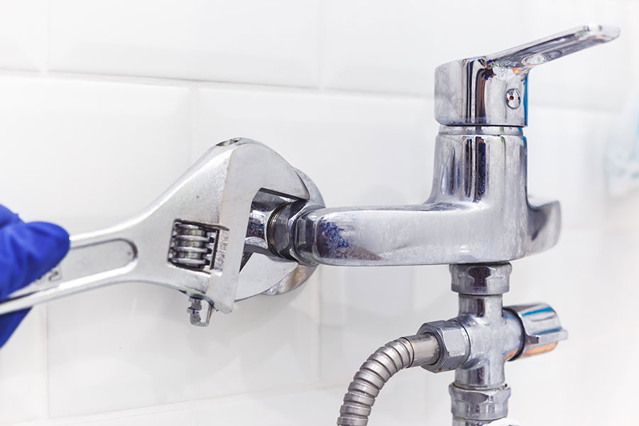 plumber-uses-pipe-wrench-for-service-shower-mixer